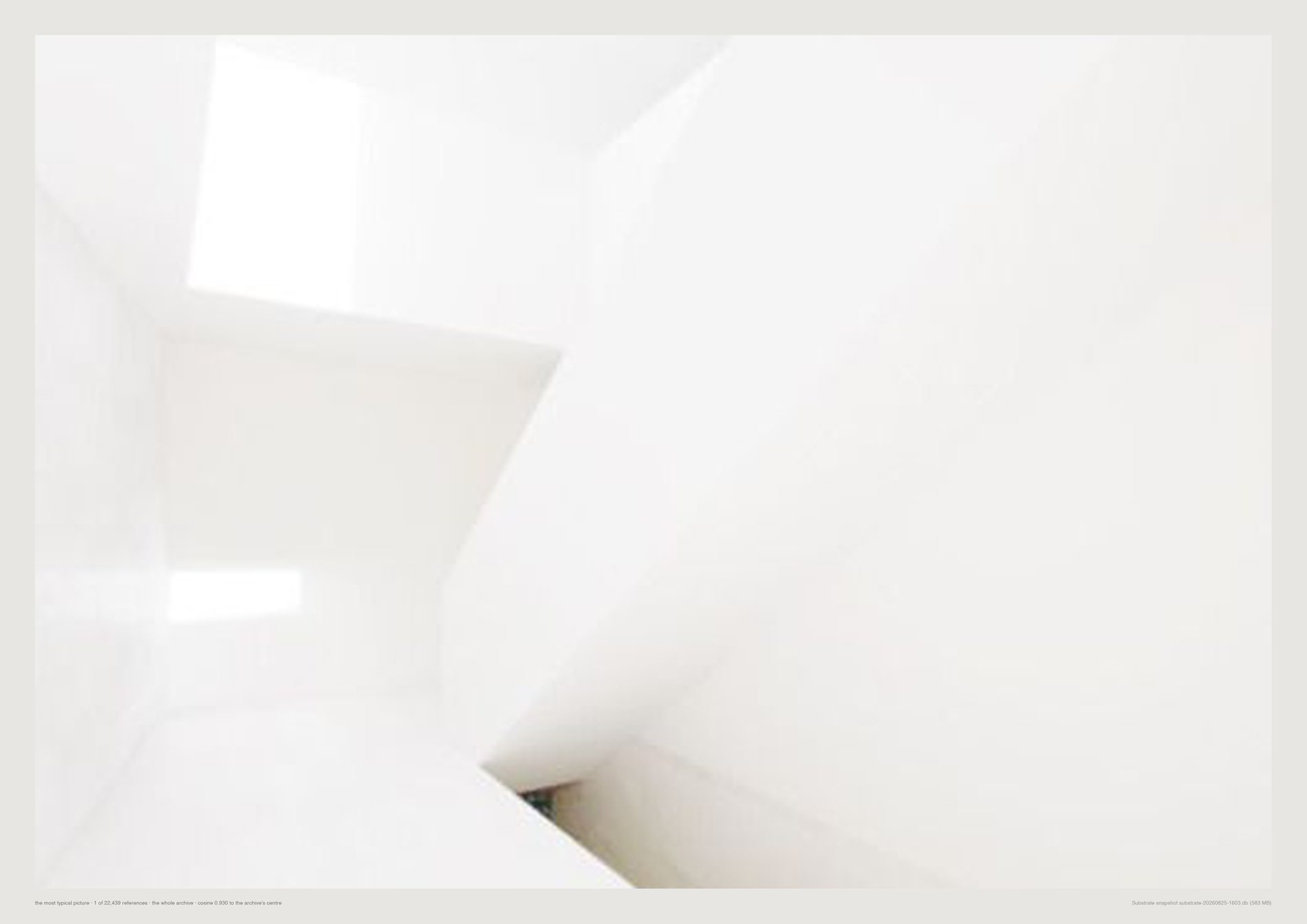 A white architectural interior with a shaft of daylight.